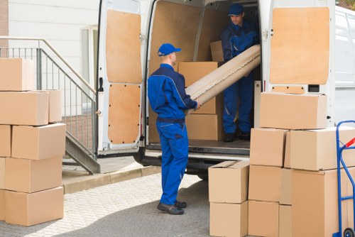 Flat removals team handling boxes and furniture in Bickley