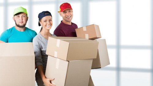 Local removal team loading items into a van