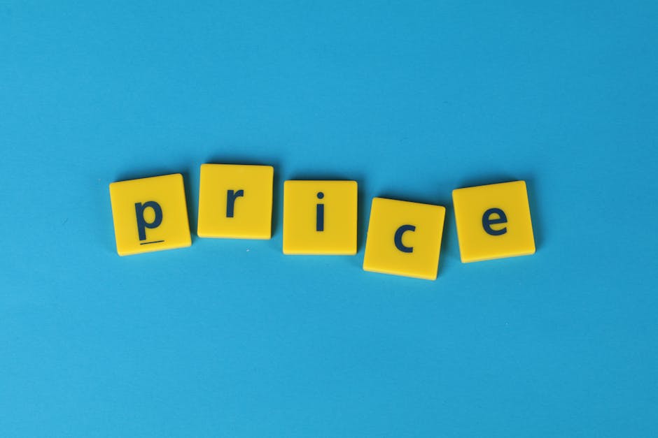 Five yellow plastic letter tiles spelling the word 'price' are arranged on a flat light blue background. The tiles are positioned in a slightly curved line, with each tile displaying a single lowercase letter in dark blue. The first tile, with the letter 'p', is at the left, followed by tiles with 'r', 'i', 'c', and 'e' moving towards the right. The background is evenly lit, creating a clean, minimalistic appearance. This image captures a straightforward, visual representation of costs or pricing, which is relevant to house removals and moving services offered by Man and Van Bickley, especially in the context of explaining local removals pricing for Bickley homeowners in the BR1 area. The simplicity and clarity of the image make it suitable for illustrating topics related to home relocation costs, packing and moving expenses, or furniture transport services.
